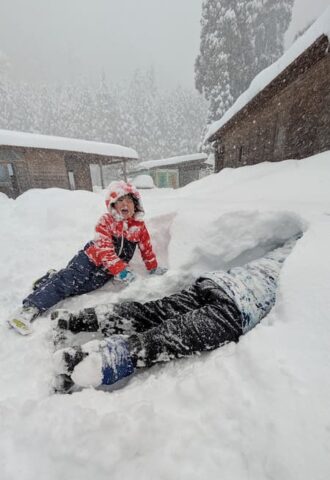 雪まみれになって遊ぶ男の子たち